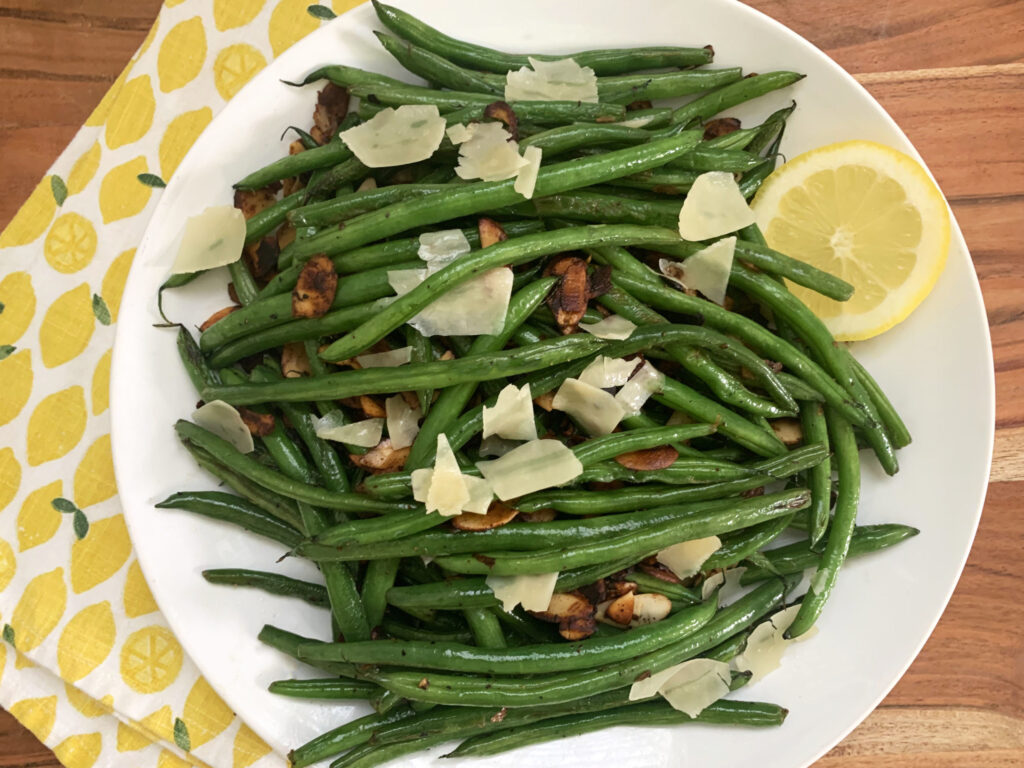 Top view of a white dinner plate filled with sauteed Crystal Valley Foods French Green Beans