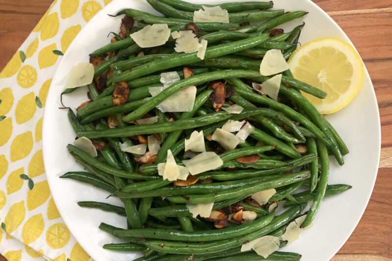 Top view of a white dinner plate filled with sauteed Crystal Valley Foods French Green Beans